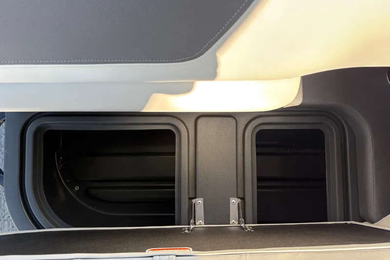 Slide: The Image of 2027 Sun Tracker Fishin' Barge 22 DLX storage compartment, open and empty. - 21