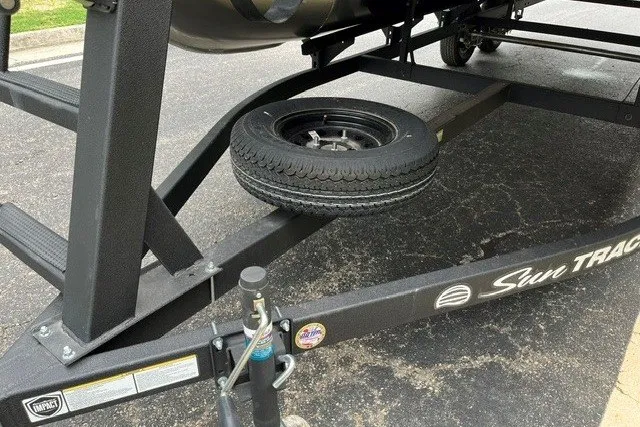 Slide: The Image of Trailer of 2027 Sun Tracker Party Barge 20 DLX with spare tire on asphalt. - 13