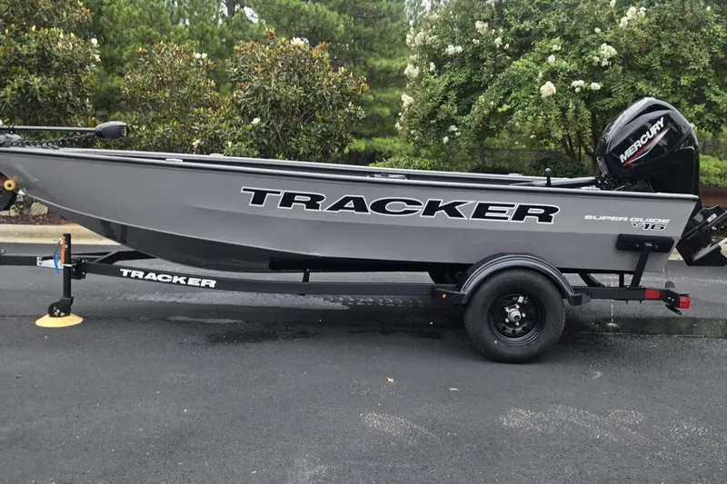 The Image of 2027 Tracker Super Guide V-16 T boat on trailer, parked outdoors. - 0