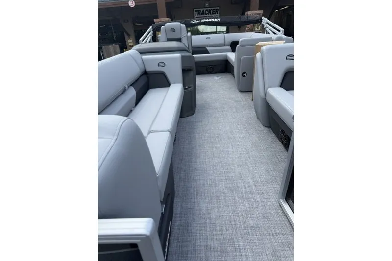 Slide: The Image of 2027 Sun Tracker Party Barge 20 DLX interior with gray seating and flooring. - 13