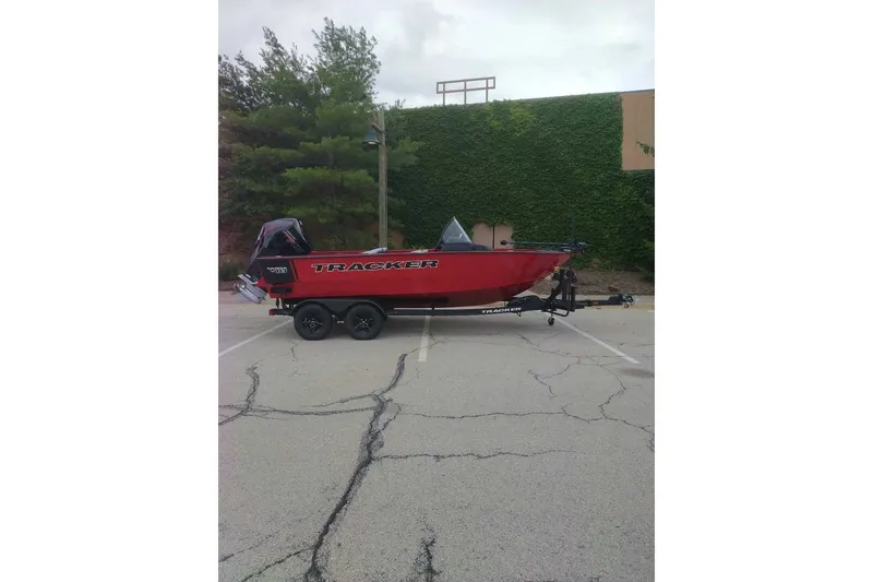 The Image of Red 2027 Tracker Targa V-18 WT boat on trailer in parking lot. - 0