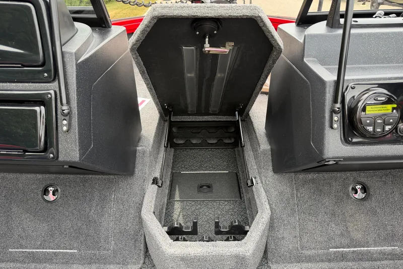 Slide: The Image of 2027 Tracker Targa V-18 WT boat interior with open storage compartment and control panel. - 14