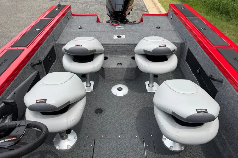 Slide: The Image of 2027 Tracker Targa V-18 WT boat interior with four gray seats and red accents. - 13