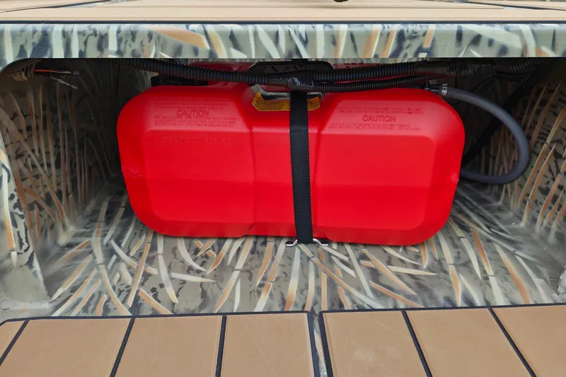 Slide: The Image of Red fuel tank in 2027 Tracker Grizzly 1756 T Marsh boat compartment. - 22