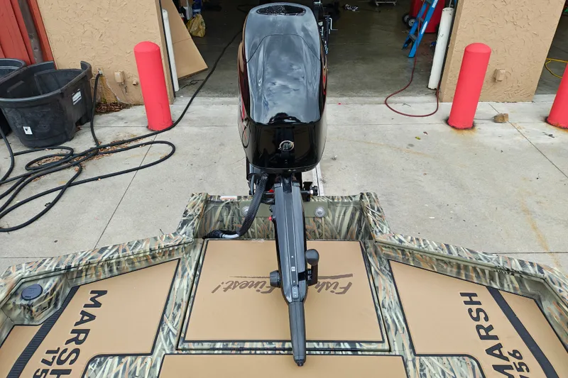 Slide: The Image of 2027 Tracker Grizzly 1756 T Marsh boat with camo design and outboard motor. - 23