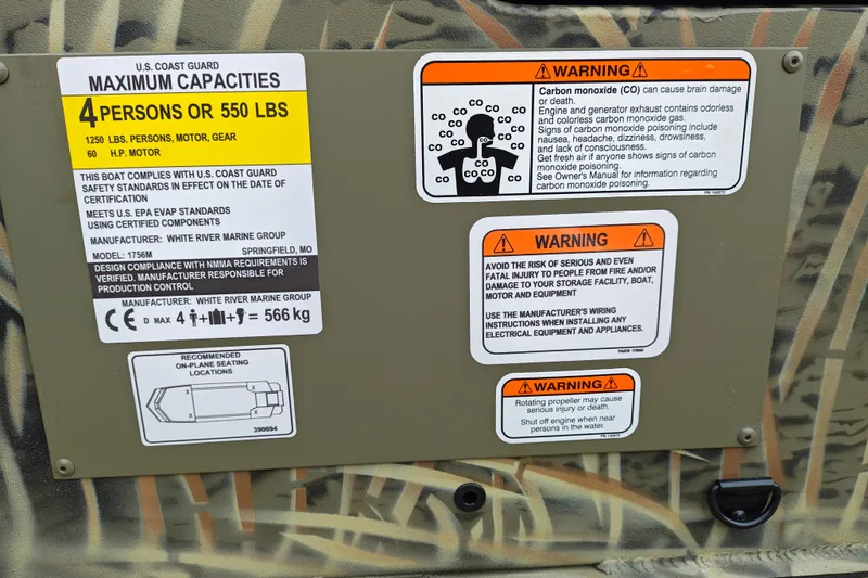 Slide: The Image of 2027 Tracker Grizzly 1756 T Marsh boat capacity and safety warning labels. - 21