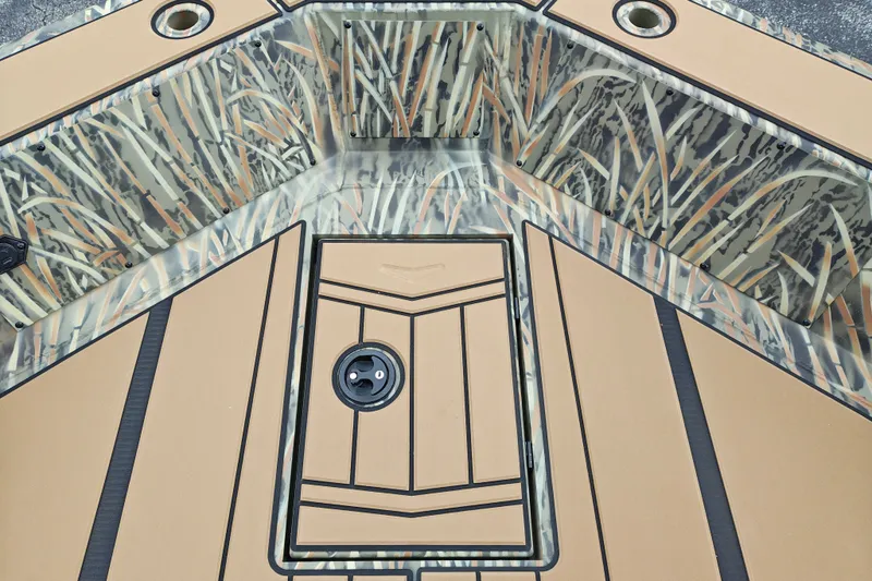 Slide: The Image of 2027 Tracker Grizzly 1756 T Marsh boat deck with camouflage pattern and storage compartments. - 16