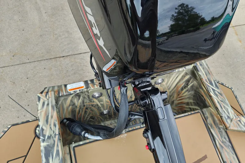 Slide: The Image of Outboard motor on 2027 Tracker Grizzly 1756 T Marsh boat with camouflage design. - 24