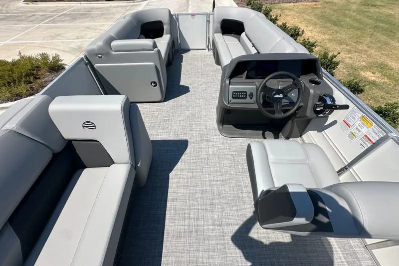 Slide: The Image of 2027 Sun Tracker Party Barge 20 DLX interior with gray seating and steering console. - 19