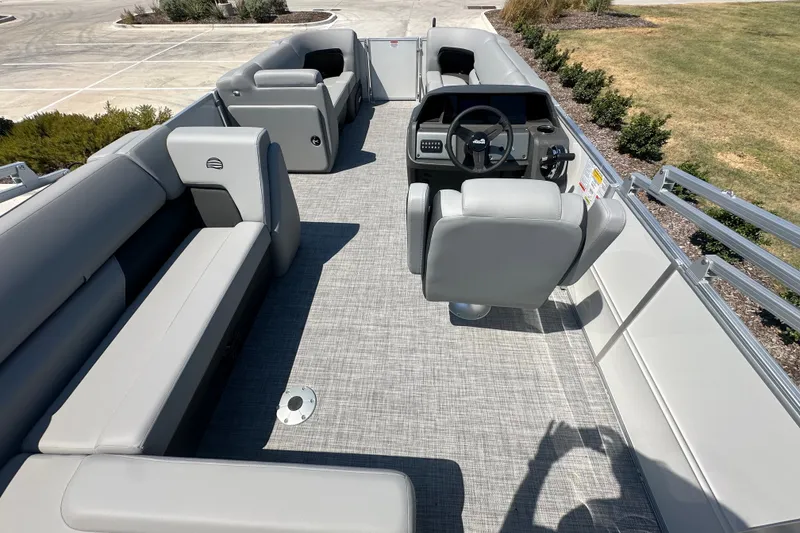 Slide: The Image of 2027 Sun Tracker Party Barge 20 DLX interior with gray seating and steering console. - 17