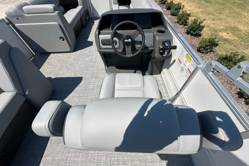 Slide: The Image of 2027 Sun Tracker Party Barge 20 DLX interior with gray seating and steering console. - 18