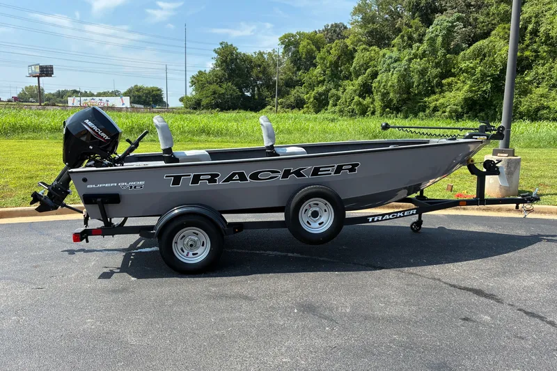 The Image of 2027 Tracker Super Guide V-16 T boat on trailer, parked outdoors. - 0
