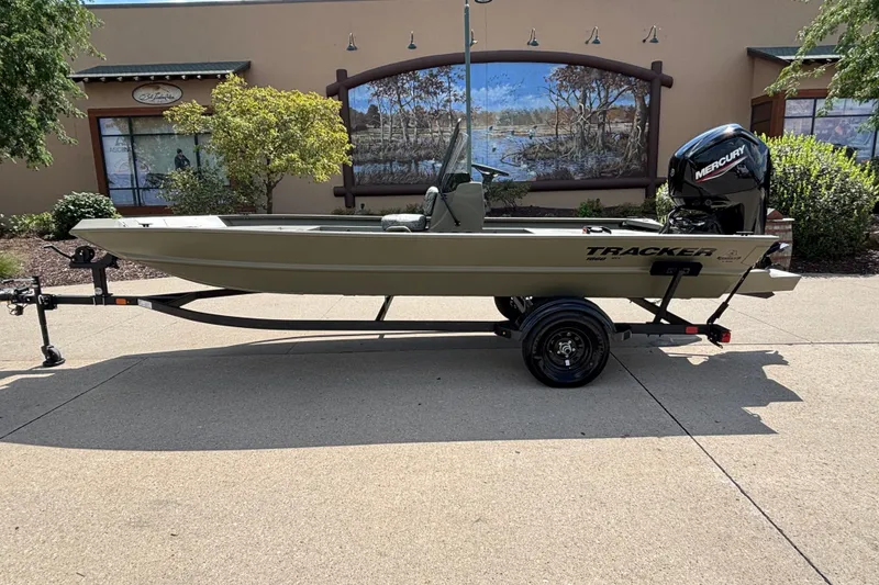 The Image of 2027 Tracker Grizzly 1860 CC boat on trailer, outdoors, with Mercury engine. - 0