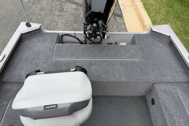 Slide: The Image of 2027 Tracker Super Guide V-16 T boat interior with gray seating and motor. - 14