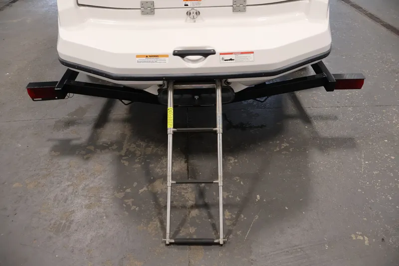 Slide: The Image of Rear view of a 2019 Scarab 165 G boat with a metal boarding ladder. - 29