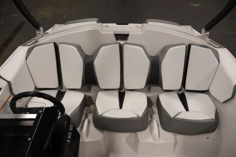 Slide: The Image of Interior seating of a 2019 Scarab 165 G boat, featuring modern white and gray upholstery. - 22