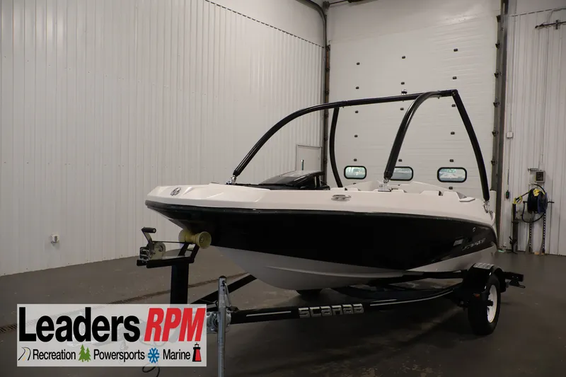 The Image of 2019 Scarab 165 G boat in showroom, displayed on trailer, Leaders RPM branding visible. - 0