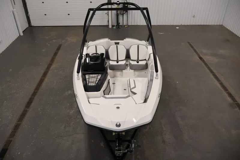 Slide: The Image of 2019 Scarab 165 G boat in a garage, showcasing sleek design and seating arrangement. - 8