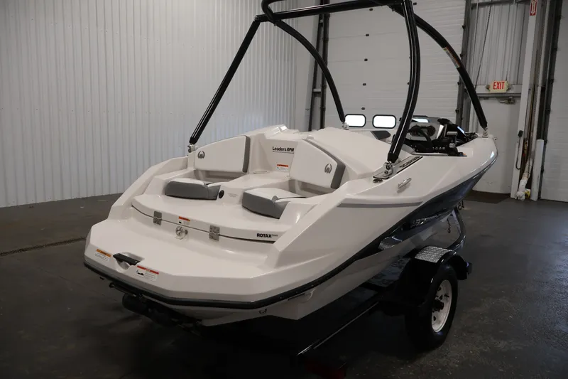 Slide: The Image of 2019 Scarab 165 G boat in a garage, showcasing sleek design and Rotax engine. - 4