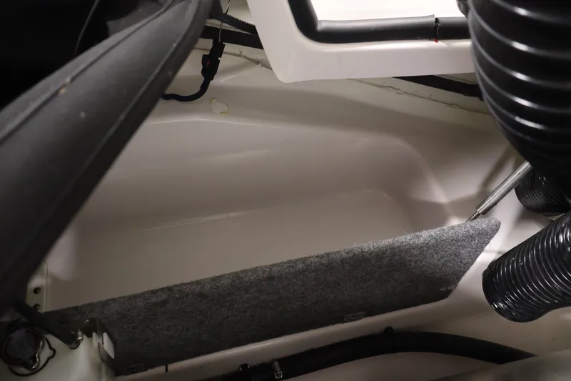 Slide: The Image of Interior view of a 2019 Scarab 165 G boat, showcasing storage compartment details. - 25