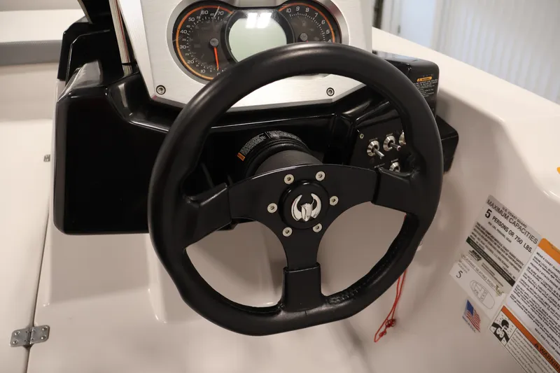 Slide: The Image of Steering wheel and dashboard of 2019 Scarab 165 G boat, featuring speedometer and controls. - 17
