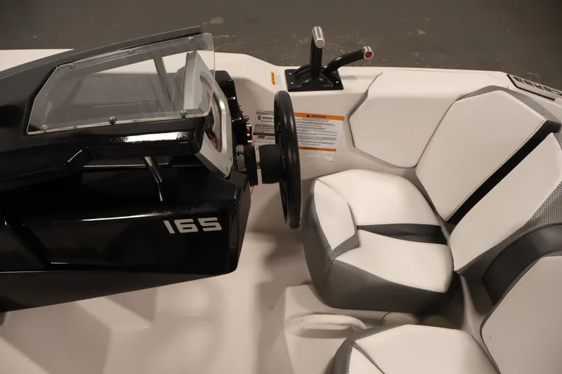 Slide: The Image of Cockpit of 2019 Scarab 165 G boat with steering wheel and seating. - 16