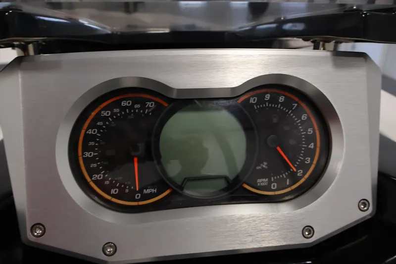 Slide: The Image of Dashboard of a 2019 Scarab 165 G boat, featuring speedometer and tachometer gauges. - 18