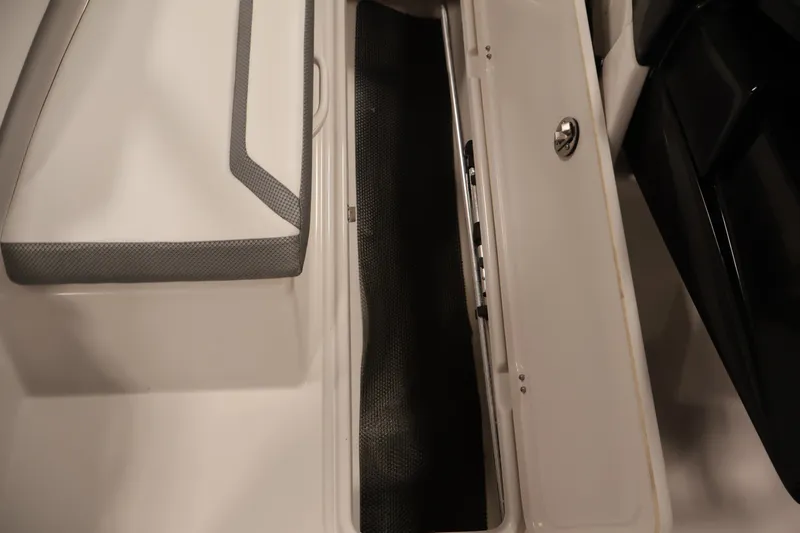 Slide: The Image of Storage compartment in a 2019 Scarab 165 G boat, featuring sleek design and secure latch. - 15