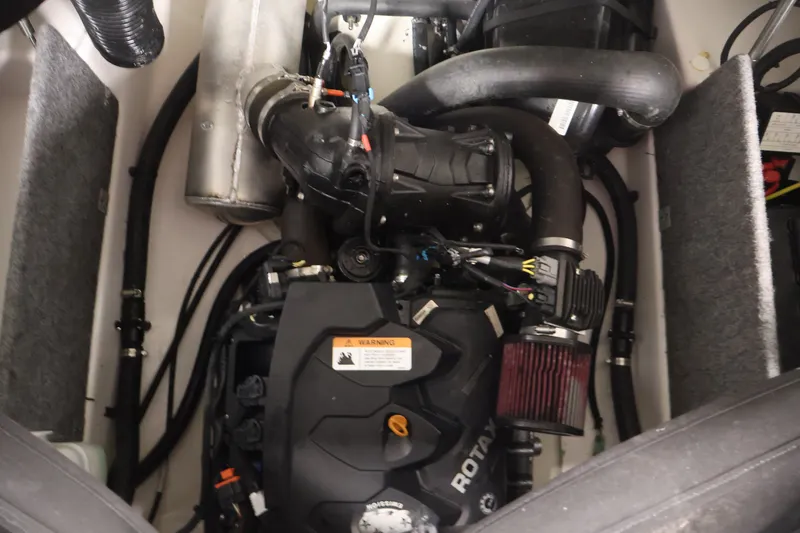 Slide: The Image of Engine compartment of a 2019 Scarab 165 G boat, featuring Rotax components. - 23