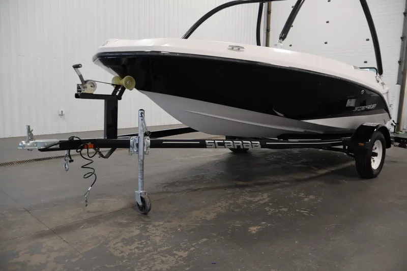 Slide: The Image of 2019 Scarab 165 G boat on trailer in indoor setting. - 31