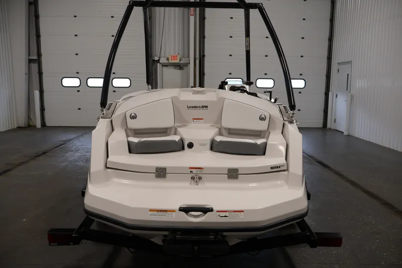 Slide: The Image of 2019 Scarab 165 G boat in a garage, rear view with seating and Rotax engine. - 5