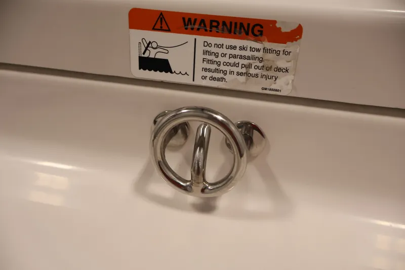 Slide: The Image of Warning label and metal fitting on 2019 Scarab 165 G boat deck. - 27