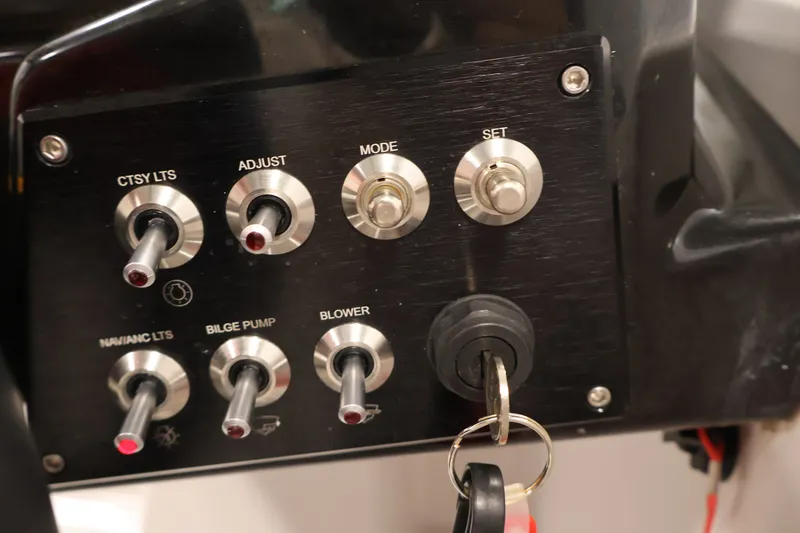 Slide: The Image of Control panel of a 2019 Scarab 165 G boat with switches and ignition key. - 19
