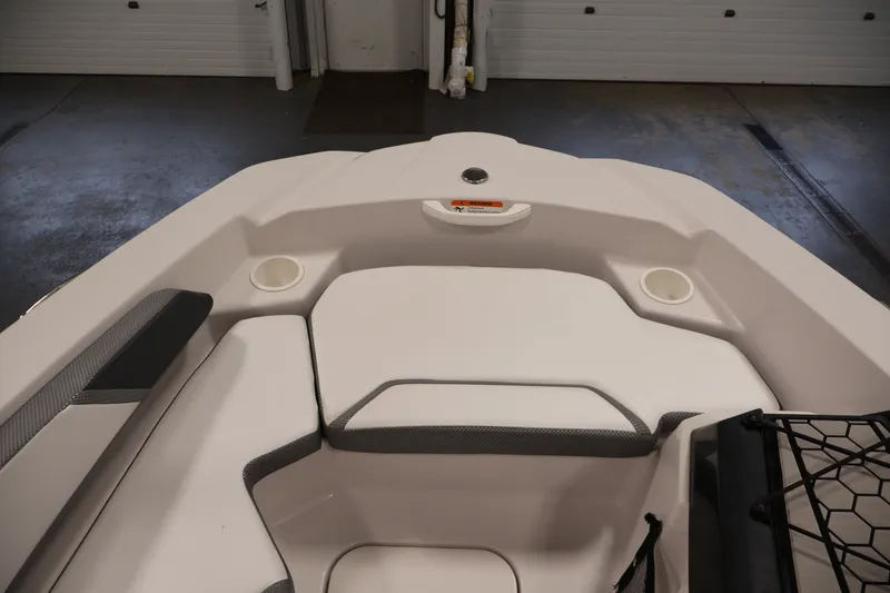 Slide: The Image of Interior of a 2019 Scarab 165 G boat, featuring seating and cup holders. - 10