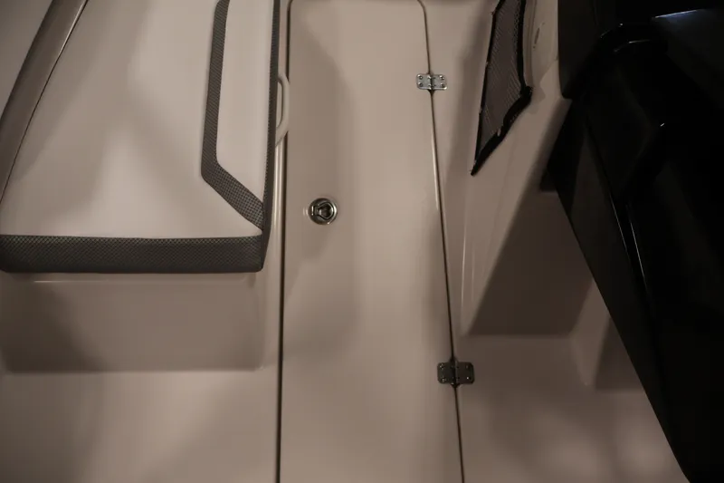 Slide: The Image of Interior view of a 2019 Scarab 165 G boat, featuring seating and storage. - 14