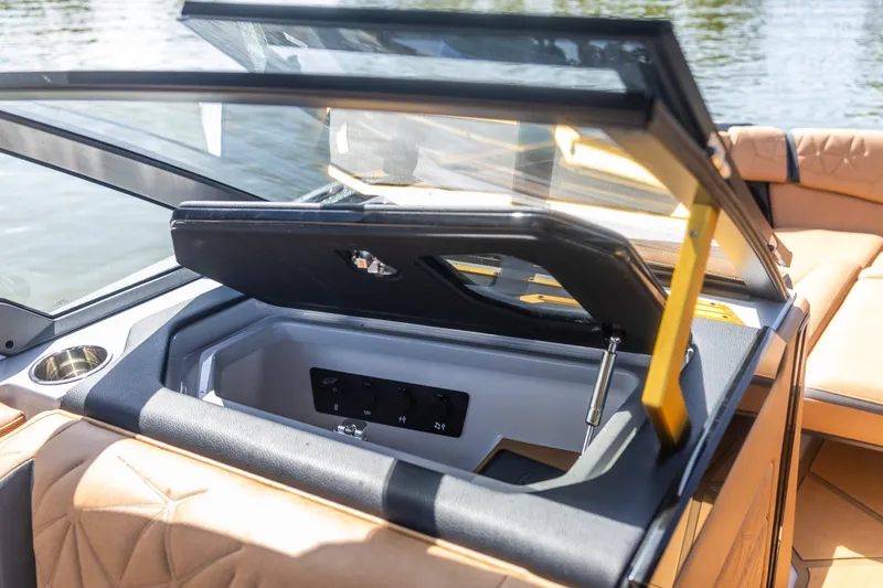Slide: The Image of 2026 Nautique Super Air Nautique G25 Paragon interior storage compartment with luxurious seating. - 3