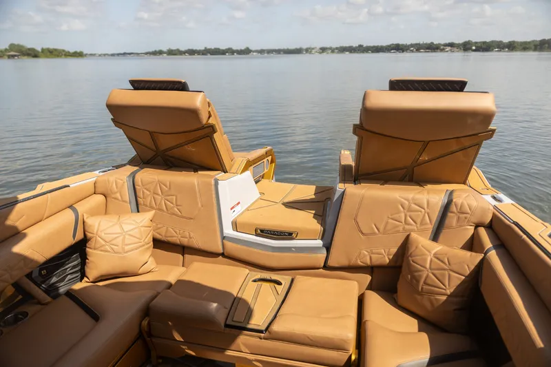 Slide: The Image of Luxurious interior of 2026 Nautique Super Air Nautique G25 Paragon boat on a serene lake. - 19
