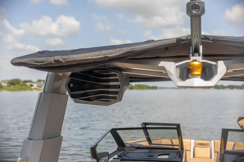 Slide: The Image of 2026 Nautique Super Air Nautique G25 Paragon boat with advanced speaker system on a lake. - 5