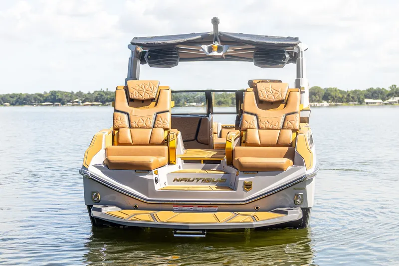 Slide: The Image of 2026 Nautique Super Air Nautique G25 Paragon on a serene lake. - 1