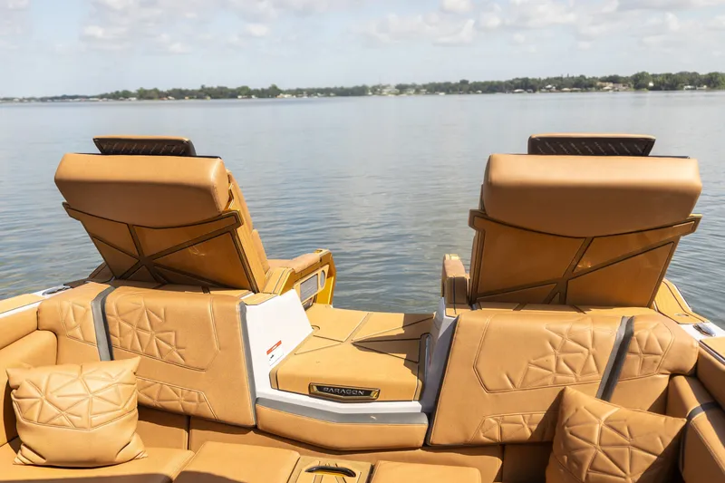 Slide: The Image of Luxurious interior of 2026 Nautique Super Air Nautique G25 Paragon on a serene lake. - 18