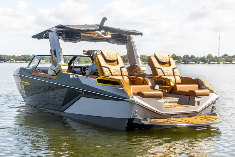 Slide: The Image of 2026 Nautique Super Air Nautique G25 Paragon luxury boat on calm water. - 11