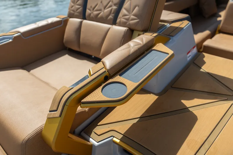 Slide: The Image of Luxurious seating and armrest detail on 2026 Nautique Super Air Nautique G25 Paragon boat. - 23