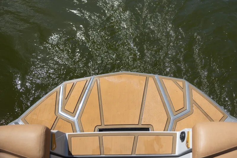 Slide: The Image of 2026 Nautique Super Air Nautique G25 Paragon swim platform above shimmering water. - 27