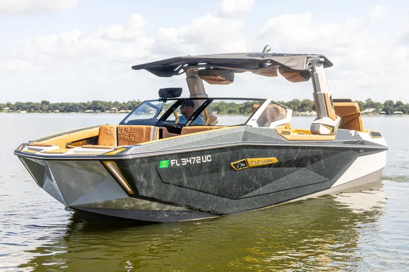 Slide: The Image of 2026 Nautique Super Air Nautique G25 Paragon boat on a lake, showcasing luxury design. - 14