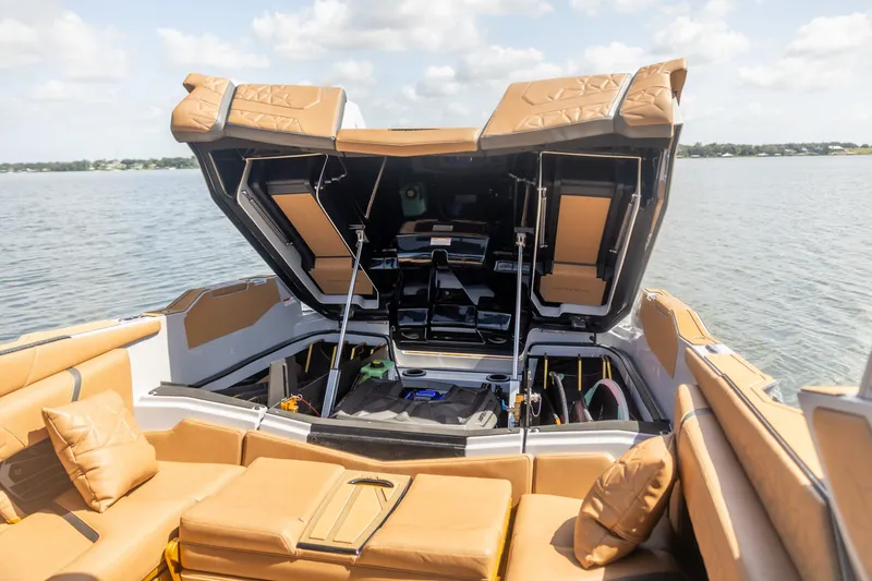 Slide: The Image of 2026 Nautique Super Air Nautique G25 Paragon boat interior with open storage compartments. - 9