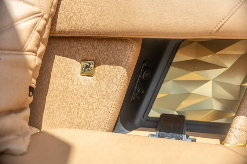 Slide: The Image of 2026 Nautique Super Air Nautique G25 Paragon interior with luxurious tan upholstery. - 25