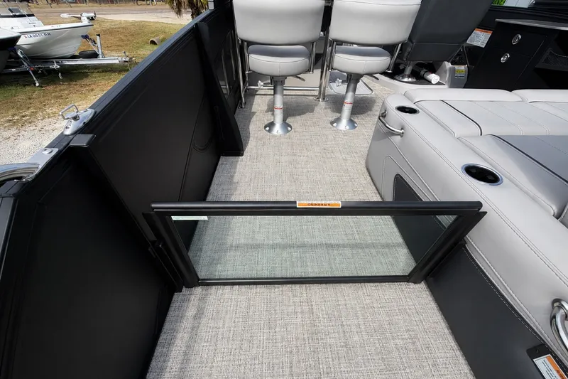 Slide: The Image of Interior of 2026 Barletta Lusso 25UE pontoon boat with seating and open gate. - 32