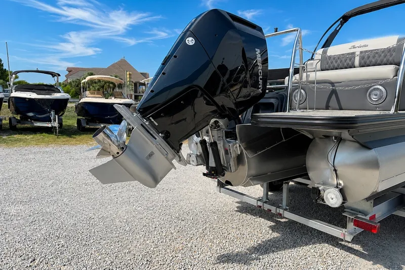 Slide: The Image of 2026 Barletta Lusso 25UE pontoon boat with Mercury outboard motor on trailer. - 38