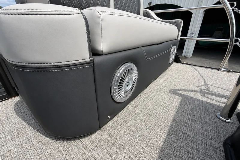 Slide: The Image of 2026 Barletta Lusso 25UE boat interior with stylish seating and integrated speaker system. - 33