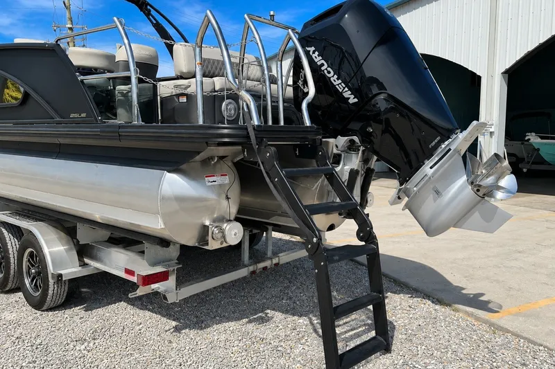 Slide: The Image of 2026 Barletta Lusso 25UE pontoon boat with Mercury outboard motor on trailer. - 37